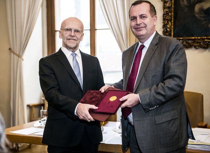 Profesor Bohuslav Gaš (vlevo) převzal zlatou medaili UK z rukou rektora Tomáše Zimy