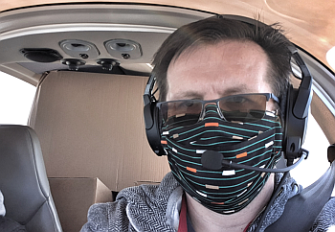 Volunteering helps: pilot Jan Bradáč on the way to Most. Behind him are boxes of 3D printed masks.